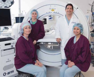 Dr. Corey Wallach and staff with the O-arm imaging machine
