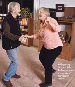 a couple dancing in their living room