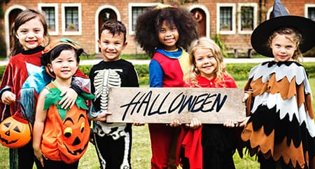 a group of cute kids in halloween costumes