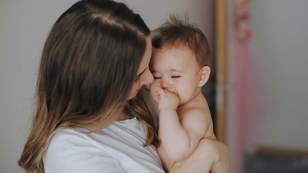 mom comforting crying baby