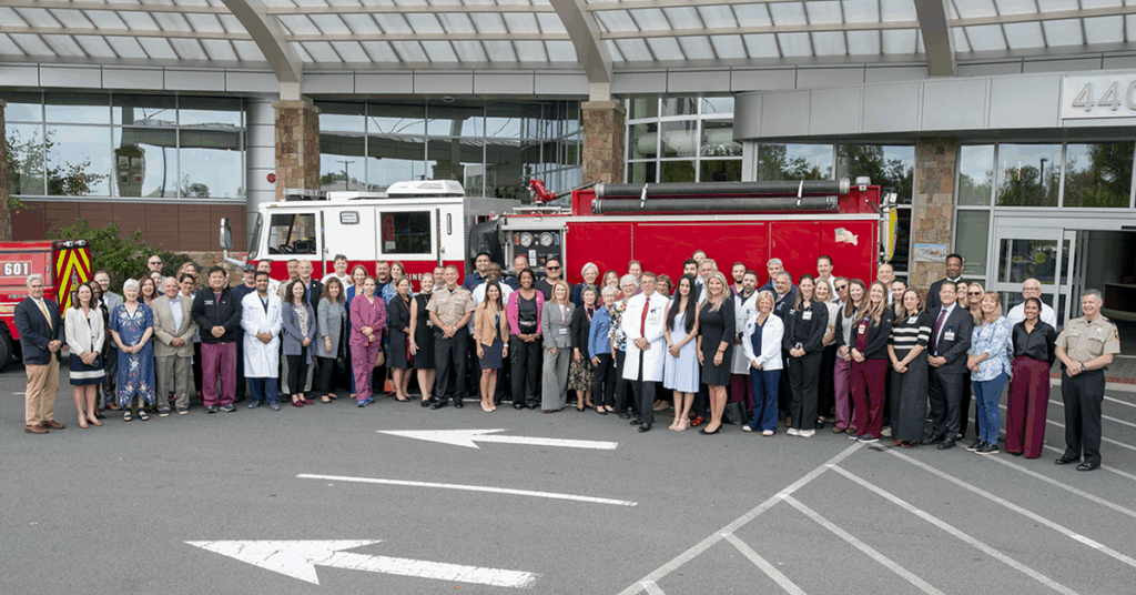 Group in front of Inova Loudoun Hospital Trauma Center marking Trauma Level II designation
